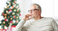 Man sitting in front of Christmas tree