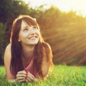 Woman in a field looking to the sky