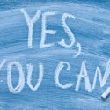 Motivational message "Yes you can!" written on a chalkboard